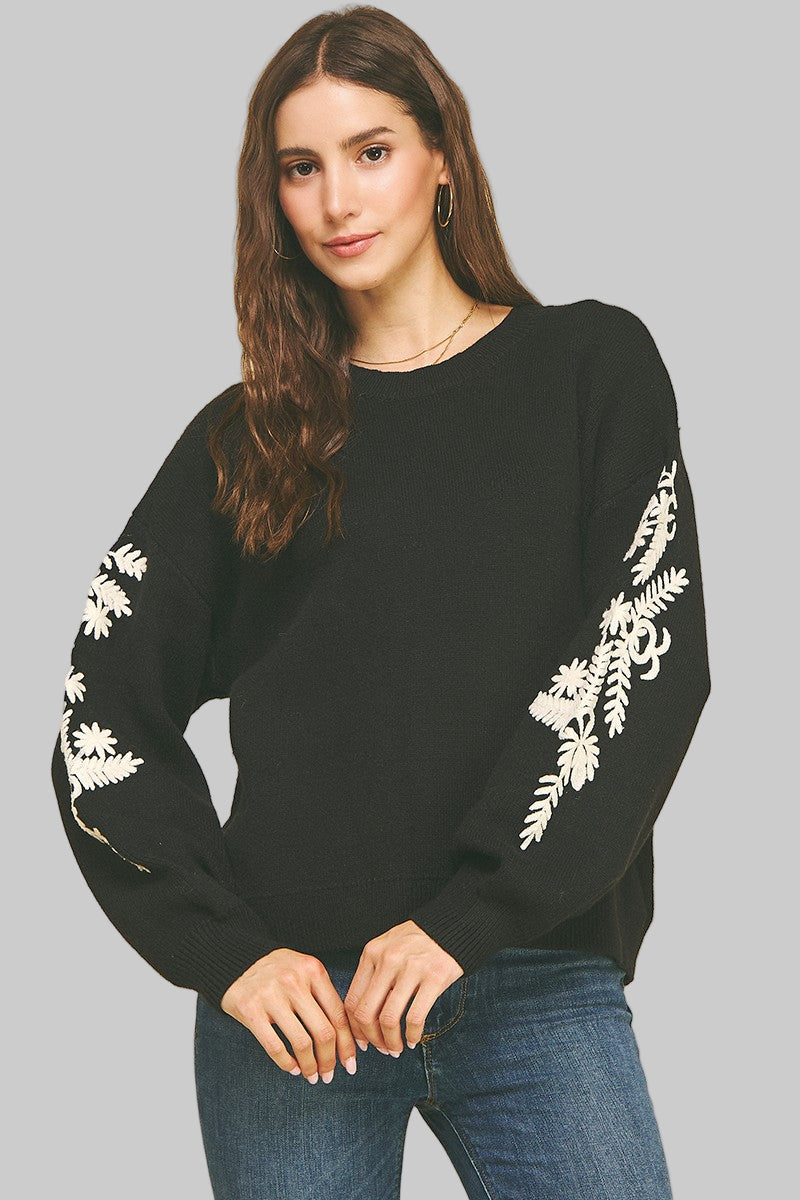 black sweater with floral sleeve detail in ivory